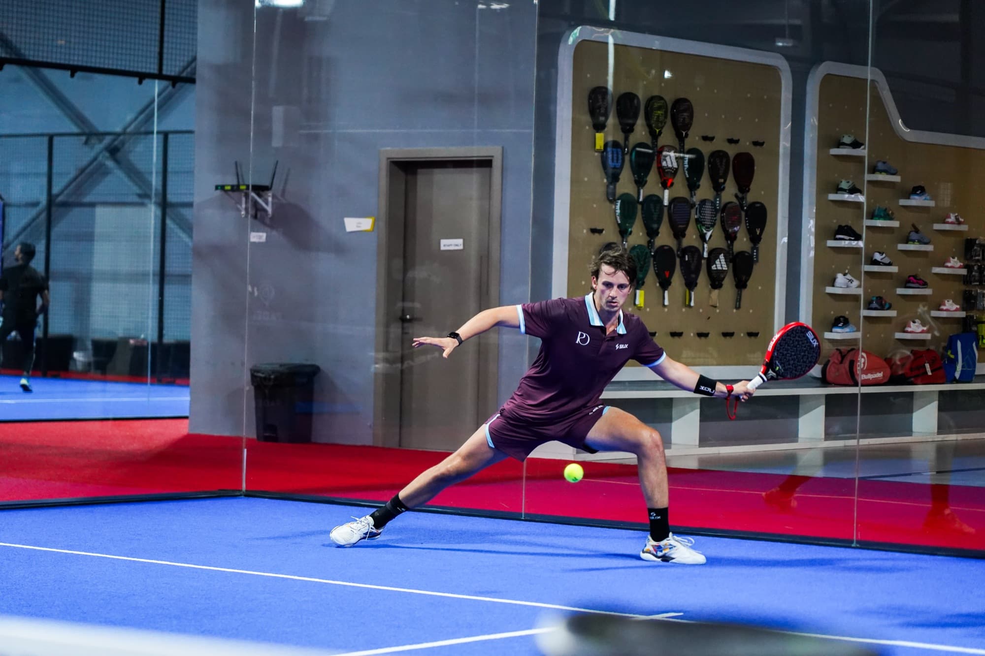 Pedro Aguilar reaching a low forehand